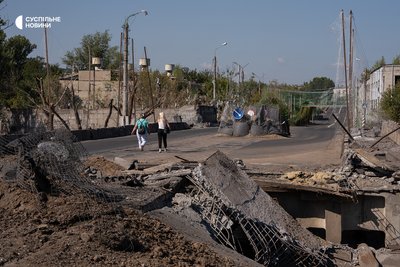Жінки проходять по мосту у Краматорську, частково зруйнованому ударами КАБів. Донеччина, вересень 2026 року Жінки проходять по мосту у Краматорську, частково зруйнованому ударами КАБів. Донеччина, вересень 2026 року