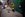 Жінки стоять на колінах, вшановуючі пам'ять загиблого бійця і односельця Олександа Максименка, у селі Княжичі на Київщині