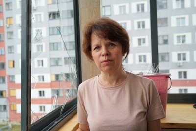 Жителька Харкова на пошкодженому балконі Жителька Харкова на пошкодженому балконі