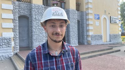 Учасник проєкту "Віднова:UA" Іван Ярема біля пошкодженої бібліотеки у Рогані Учасник проєкту "Віднова:UA" Іван Ярема біля пошкодженої бібліотеки у Рогані