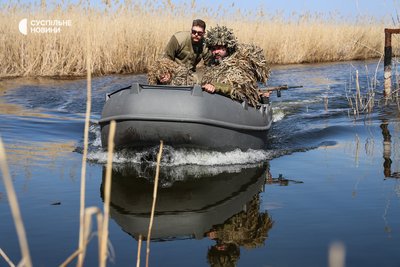 Група морпіхів підпливає до берега і готується висаджуватись на берег під час навчань на човнах Група морпіхів підпливає до берега і готується висаджуватись на берег під час навчань на човнах