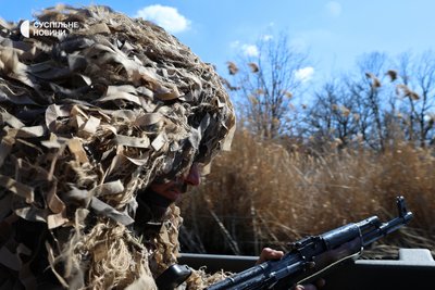 Боєць у маскувальному одязі з автоматом пливе у човні під час водних навчань для морпіхів на півдні України Боєць у маскувальному одязі з автоматом пливе у човні під час водних навчань для морпіхів на півдні України