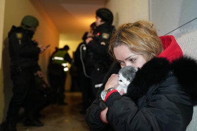 Жінка обіймає свою кішку в укритті Жінка обіймає свою кішку в укритті