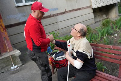 Працівник "швидкої" допомагає місцевому жителю після російської атаки на Харків Працівник "швидкої" допомагає місцевому жителю після російської атаки на Харків