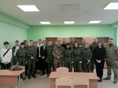 Students from one of the Mariupol schools with Russian military personnel