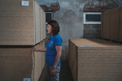 Начальниця обласного гуманітарного центру місії "Проліска" Ляна Щербина на складі, де зберігаються плити, якими зашивають вибиті вікна Начальниця обласного гуманітарного центру місії "Проліска" Ляна Щербина на складі, де зберігаються плити, якими зашивають вибиті вікна