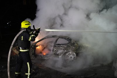 Рятувальник гасить авто, яке зайнялося через атаку російських безпілотників на Харків Рятувальник гасить авто, яке зайнялося через атаку російських безпілотників на Харків