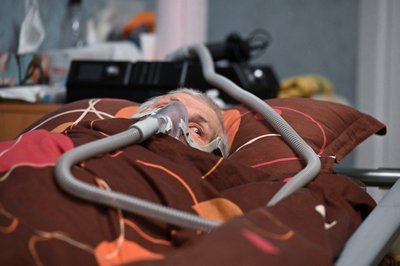 Валентин Мозговий, хворий на бічний аміотрофічний склероз, дихає завдяки респіратору вдома у Києві 21 січня 2023 року. Валентин Мозговий, хворий на бічний аміотрофічний склероз, дихає завдяки респіратору вдома у Києві 21 січня 2023 року.