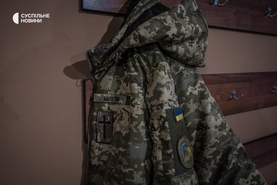 Зимова куртка капелана ЗСУ з офіційними шевронами військового капеланства очікує на пастора Євгена, поки він обідає, грудень 2022 року. Зимова куртка капелана ЗСУ з офіційними шевронами військового капеланства очікує на пастора Євгена, поки він обідає, грудень 2022 року.