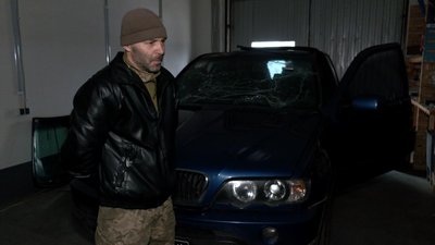 Кулеметник ДФТГ з позивним "Бумер" біля своєї автівки, яку побило уламки дрона