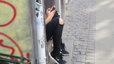 Дівчина сидить з телефоном