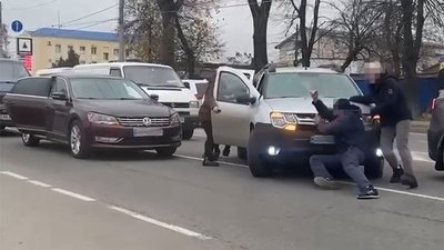Люди зупиняють автівку, що їде