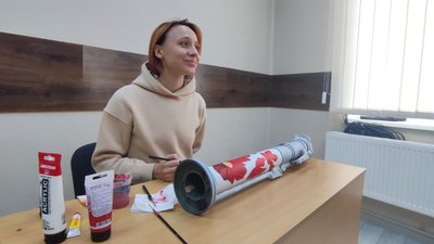 Художниця розмальовує тубус