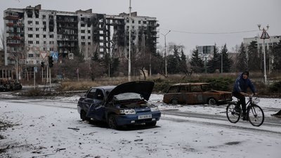 Чоловік їде велосипедом вулицею міста Костянтинівка