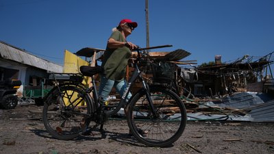 Жінка з велосипедом у Печенігах на місці влучання
