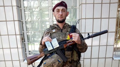 Андрій Паряк показує нагрудний знак "Золотий хрест" від Головнокомандувача Збройних сил України Андрій Паряк показує нагрудний знак "Золотий хрест" від Головнокомандувача Збройних сил України