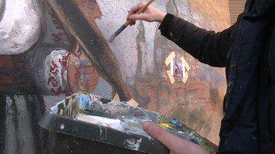Художник працює над муралом Художник працює над муралом