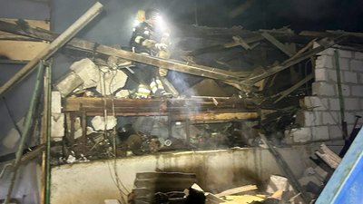 Рятувальник гасить пожежу на складі фермерського господарства, куди влучив російський БпЛА