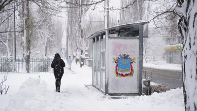 Люди йдуть повз зупинку у місті Люди йдуть повз зупинку у місті