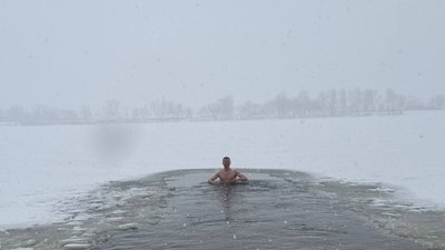 Люди занурюються у Дніпро на Водохреще