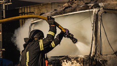 Рятувальник гасить пожежу Рятувальник гасить пожежу